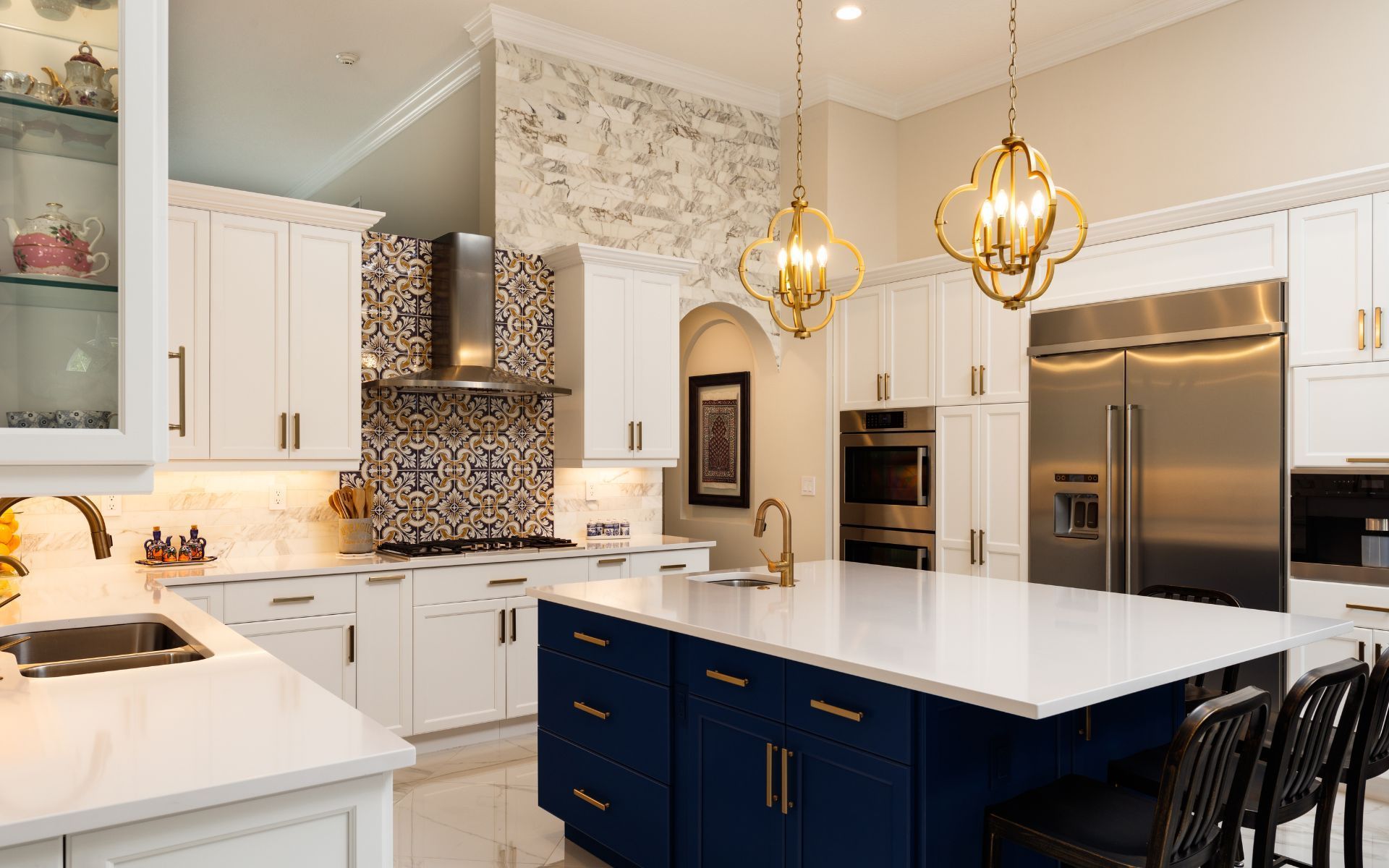 a kitchen with white cabinets , blue cabinets , stainless steel appliances and a large island .