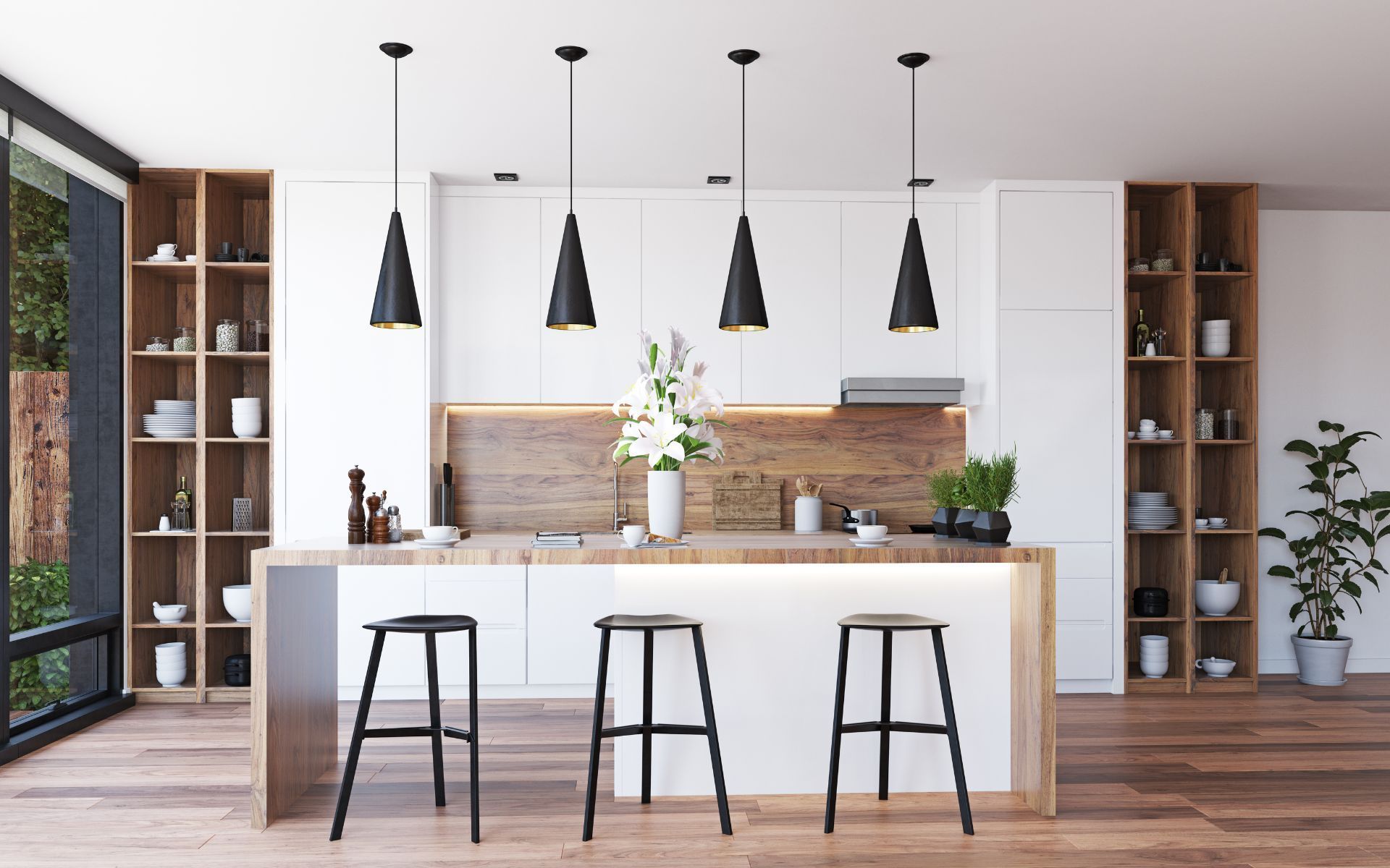 a modern kitchen with white cabinets and wooden floors and stools .
