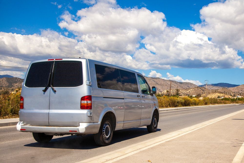 A Van Is Driving Down A Road With Mountains In The Background — Chris's Automotive & Marine Electrics In Marlow Lagoon, NT