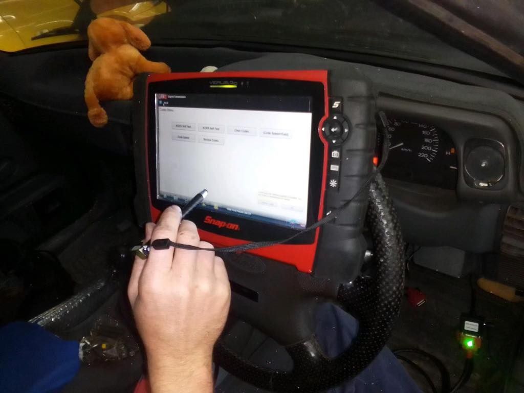 A Man Is Doing A Diagnostic — Chris's Automotive & Marine Electrics In Darwin, NT