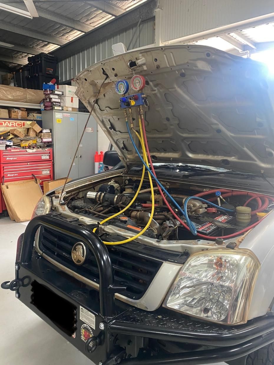 An Open Car Bonnet With Red Blue And Red Wires In A Garage — Chris's Automotive & Marine Electrics In Marlow Lagoon, NT