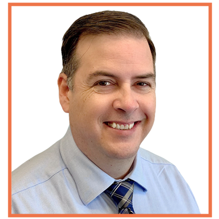 Man smiling, wearing a blue shirt and patterned tie. Orange border.