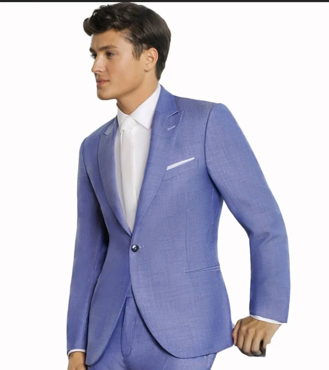 Man in a light blue suit and white tie posed against a white background.