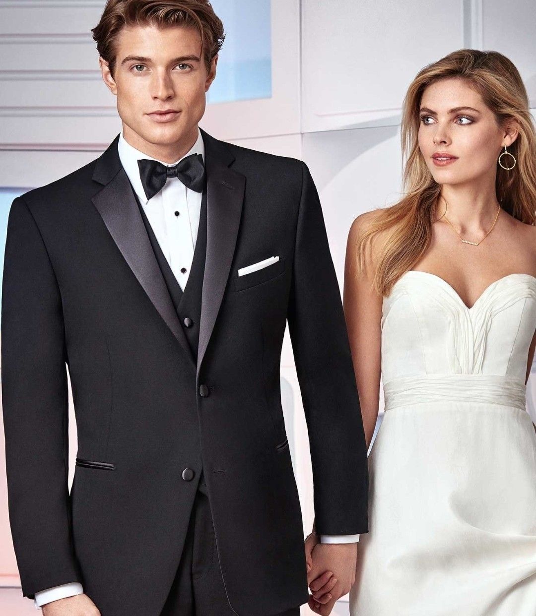 Bride and groom in formal black-and-white wedding attire, standing side by side