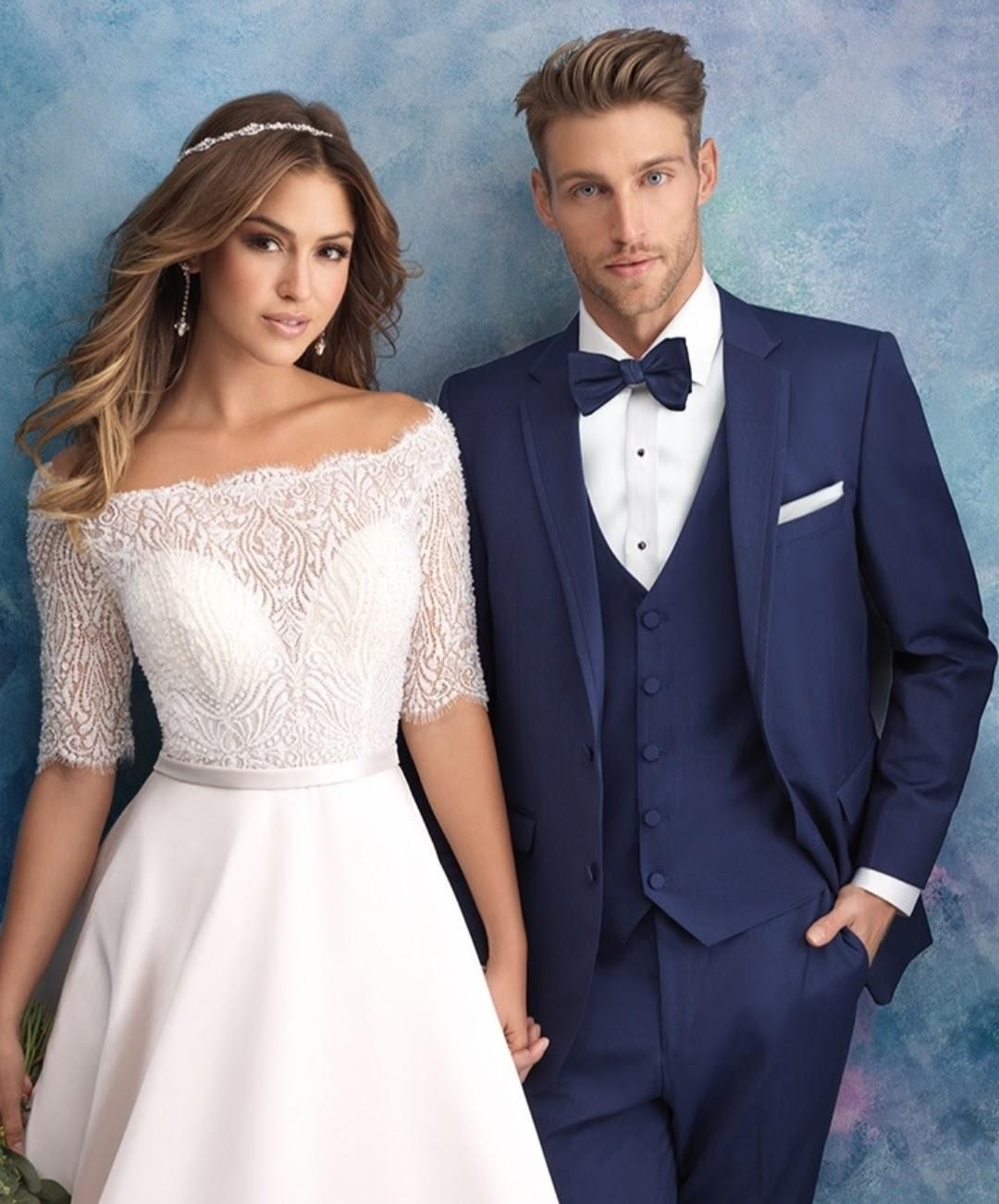 Couple in formal wedding attire, standing against a soft blue backdrop