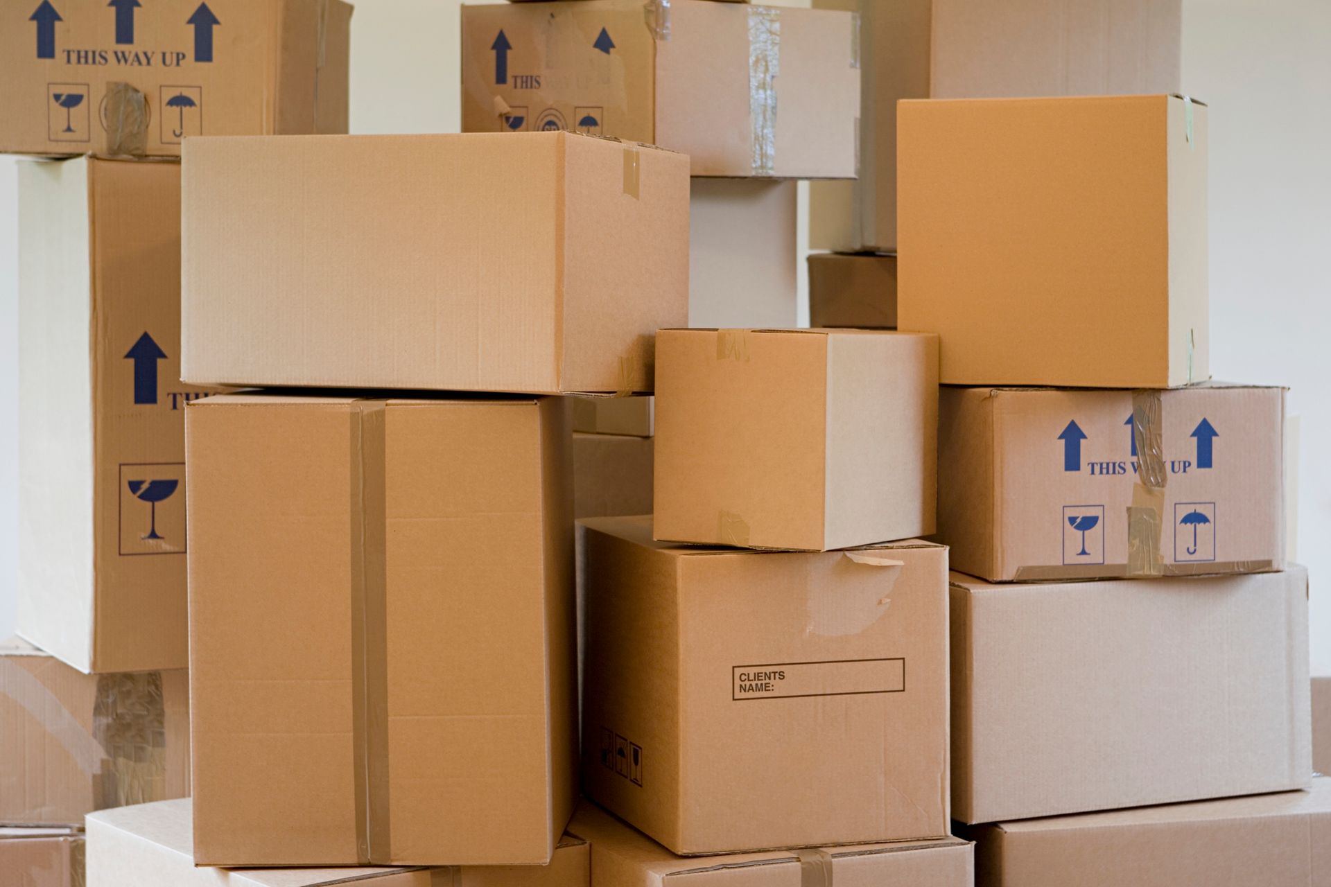 A stack of cardboard boxes in a room.
