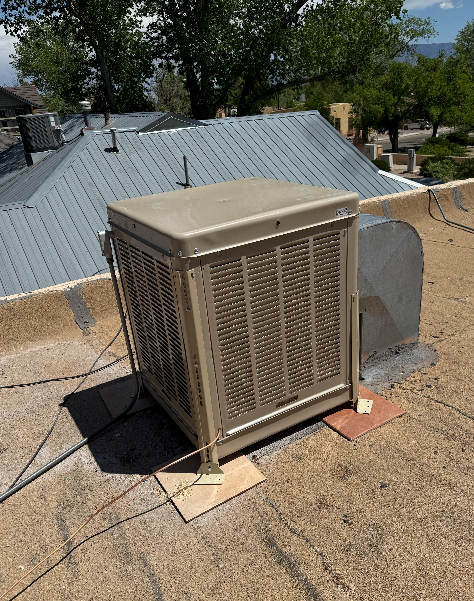 A large air conditioner is sitting on top of a roof.