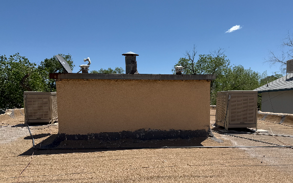 The roof of a building with a chimney on top of it