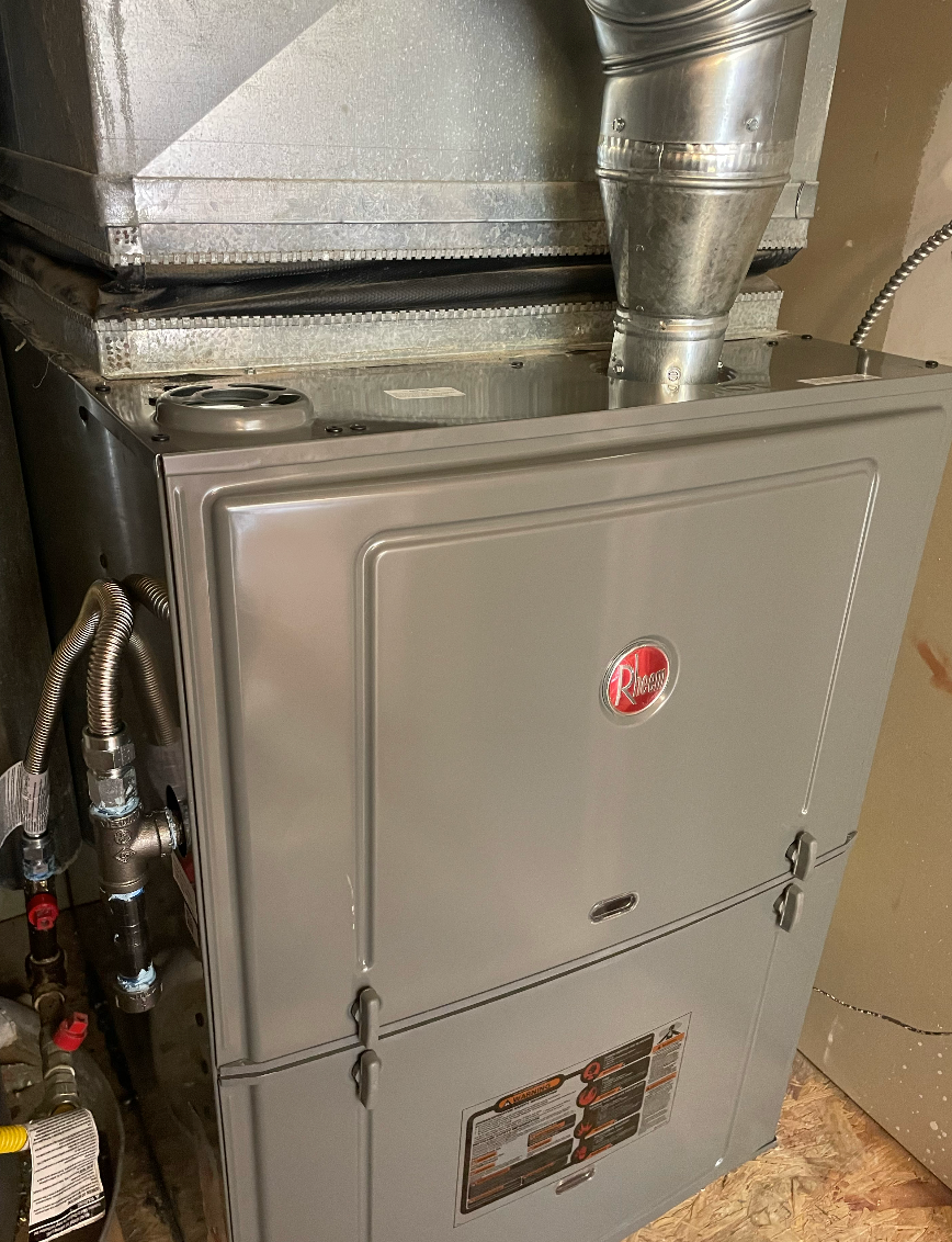 A heater is sitting on top of a stove in a room.