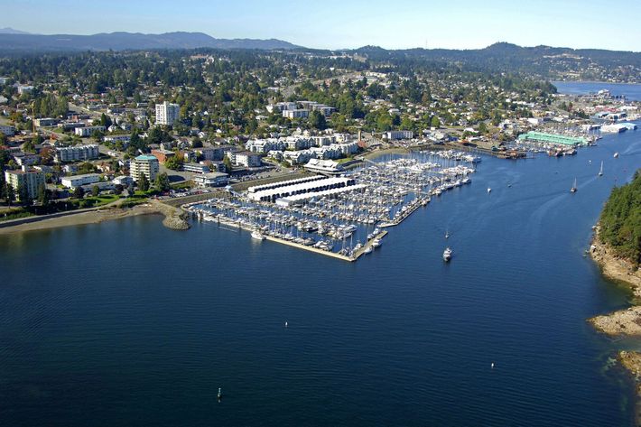 An aerial view of a large body of water with a city in the background