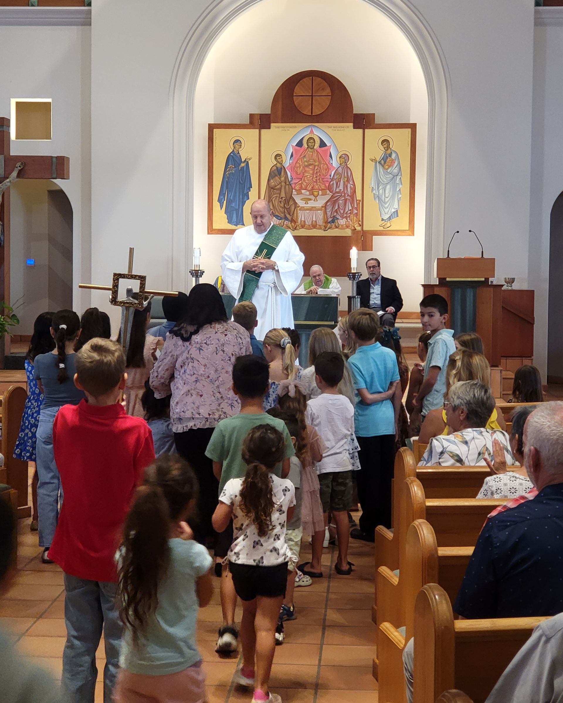 Woman leading the children to the Childrens' Liturgy classroom.