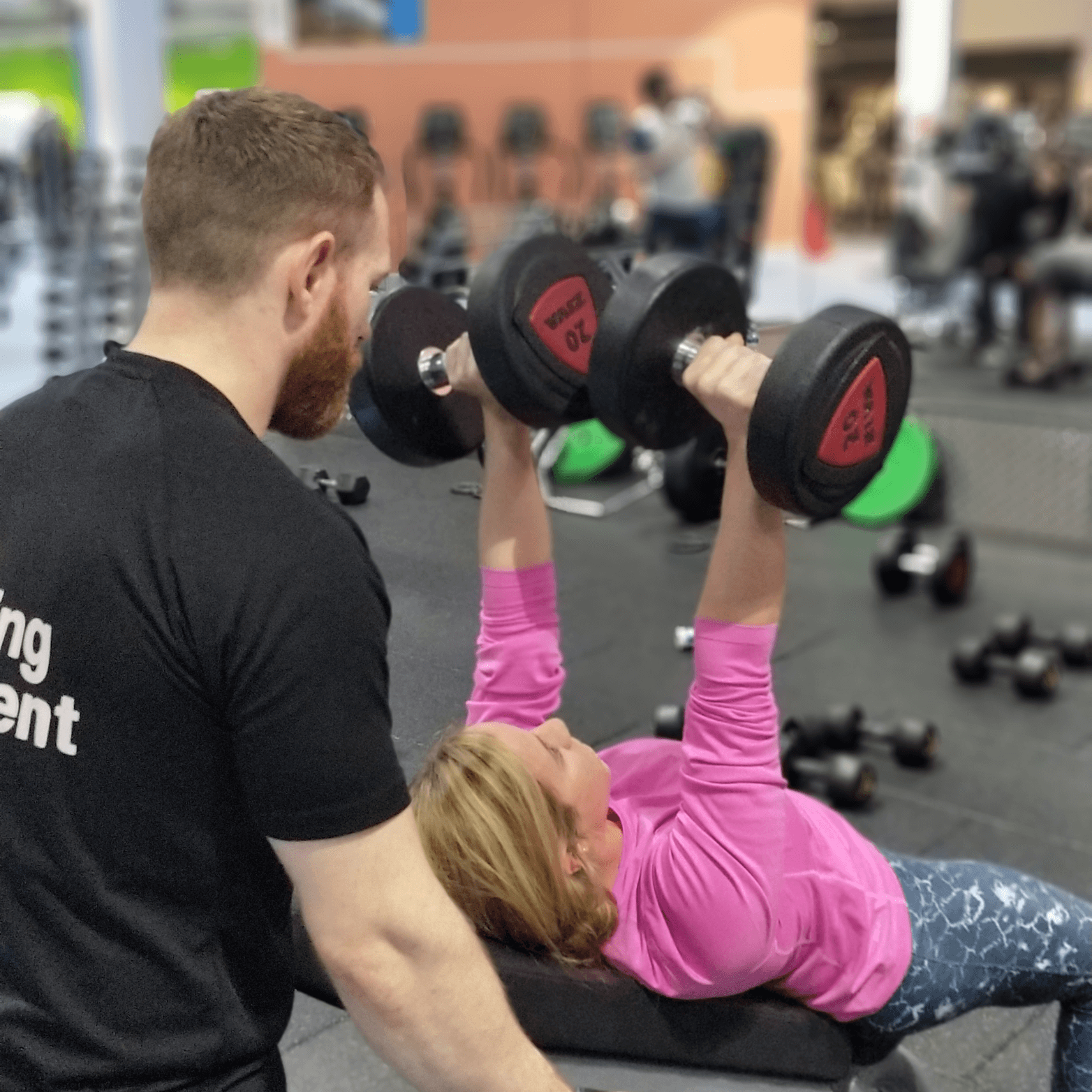 Personal training Glasgow session - trainer spotting client on incline dumbbell bench press