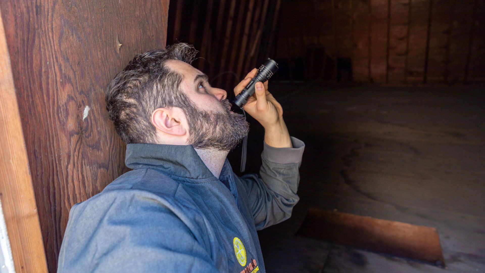 A man with a beard is looking through a magnifying glass.