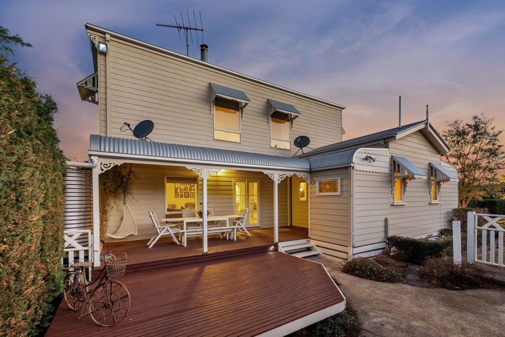 The Back Of A House With A Porch And A Table And Chairs On It — Glenn Merrick Constructions In Airlie Beach, QLD