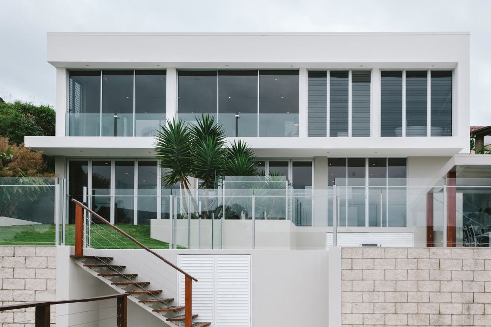 A Large White House With A Lot Of Windows — Glenn Merrick Constructions In Whitsundays, QLD