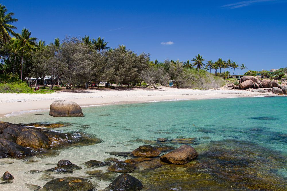 A Beach With A Lot Of Rocks In The Water — Glenn Merrick Constructions In Bowen, QLD