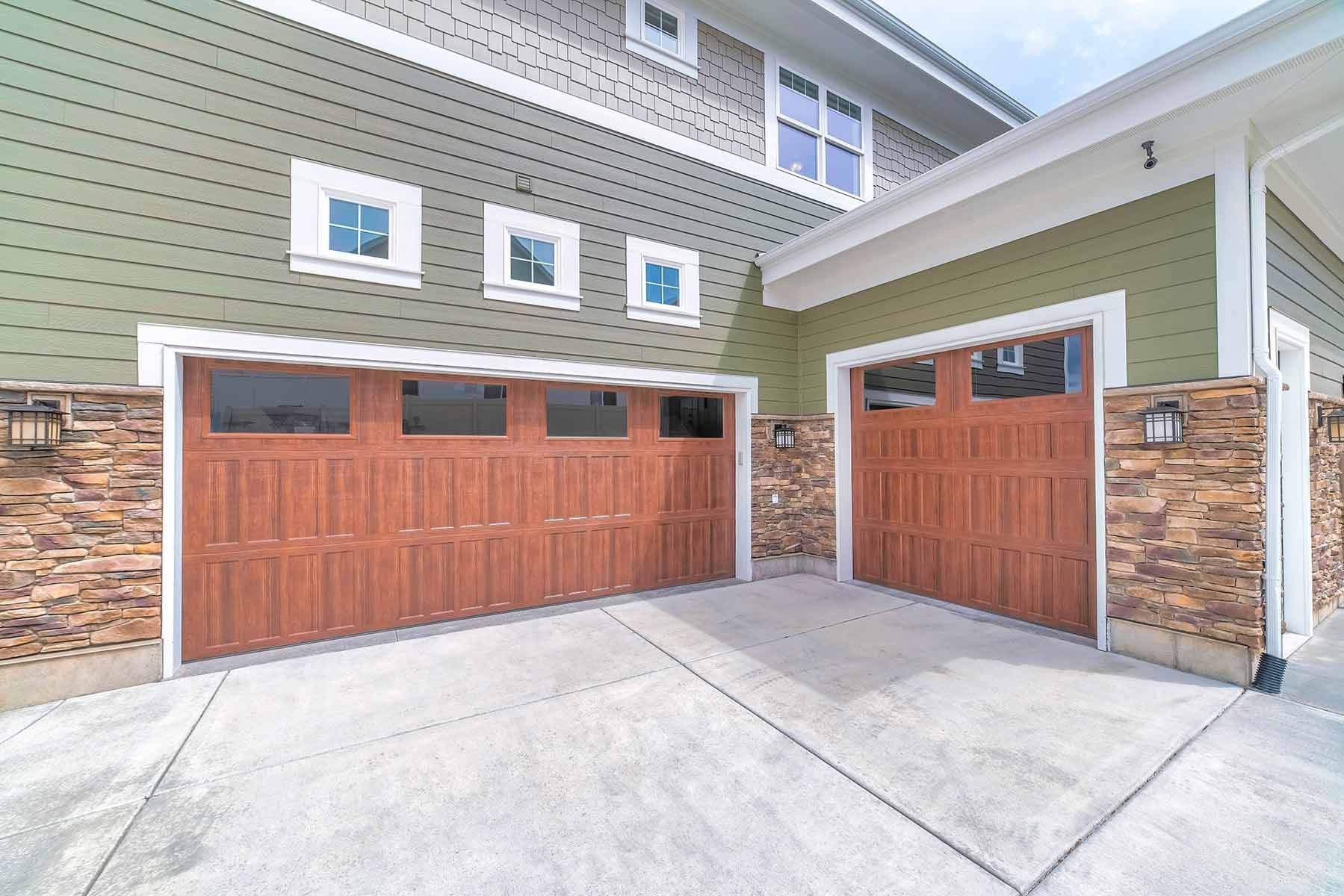 There Are Two Garage Doors On The Side Of A House — Glenn Merrick Constructions In Bowen, QLD