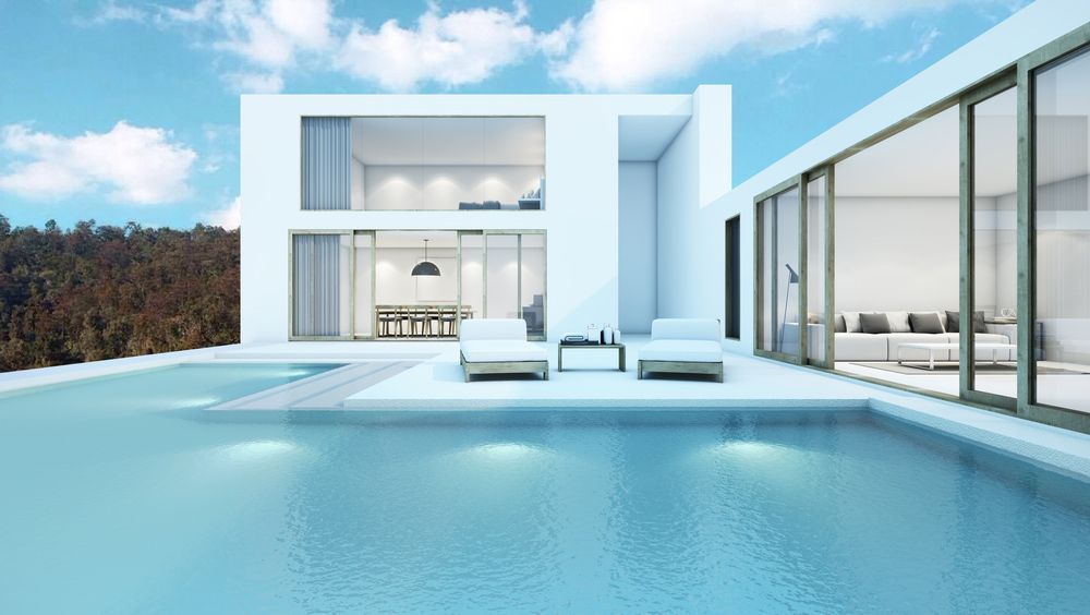 A Modern White House With A Swimming Pool In Front Of It — Glenn Merrick Constructions In Whitsundays, QLD