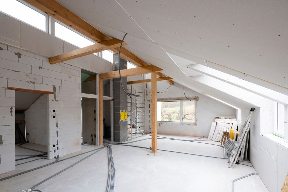 An Empty Attic With A Lot Of Windows And A Chimney — Glenn Merrick Constructions In Bowen, QLD