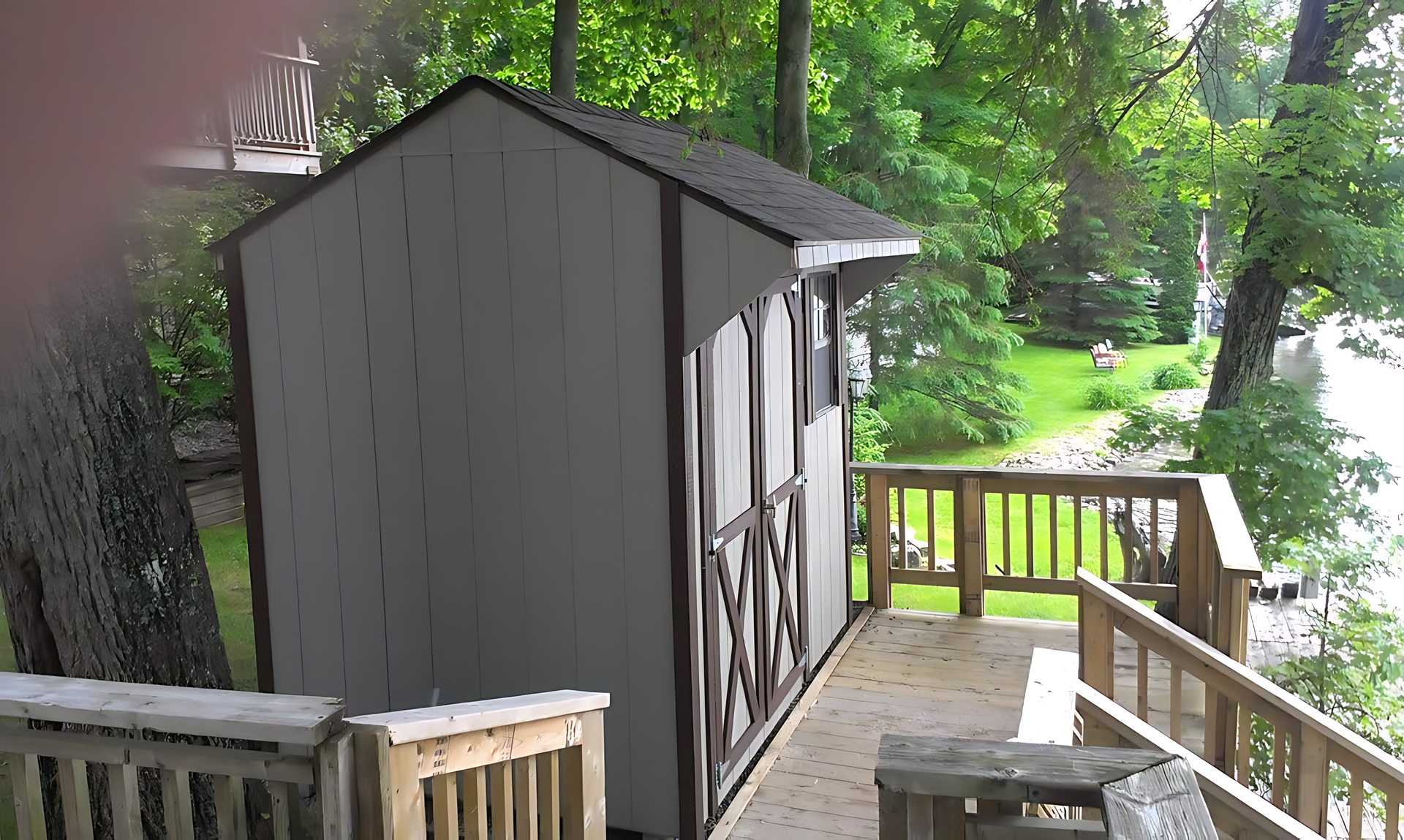 A shed on a deck overlooking a body of water