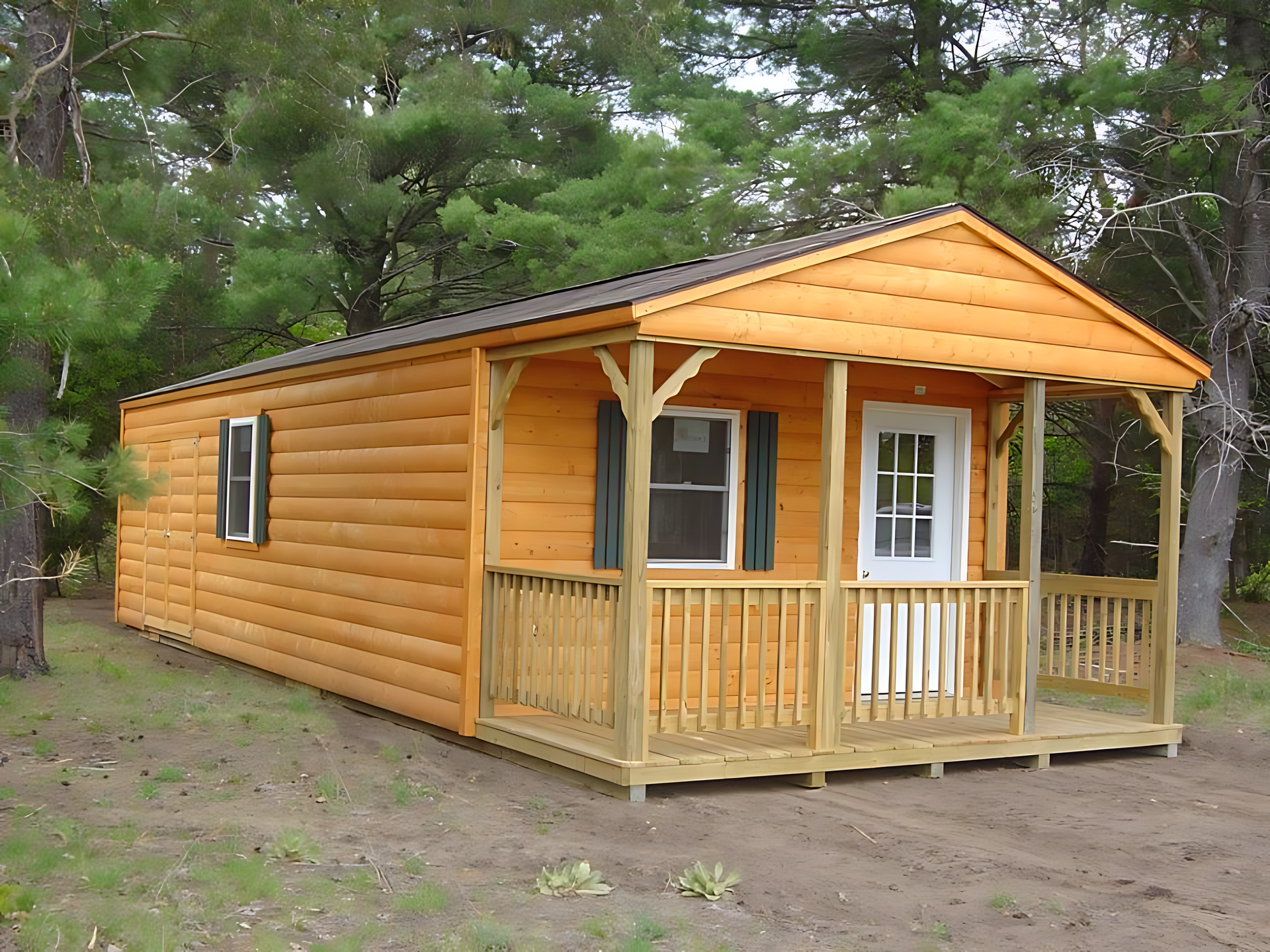 A small log cabin with a porch and trees in the background