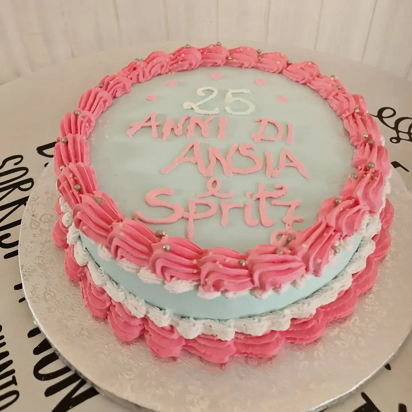 Torta glassata rosa e blu con la scritta 