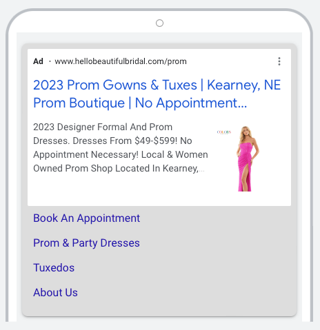 A phone with a prom gown and tuxedo ad on it.