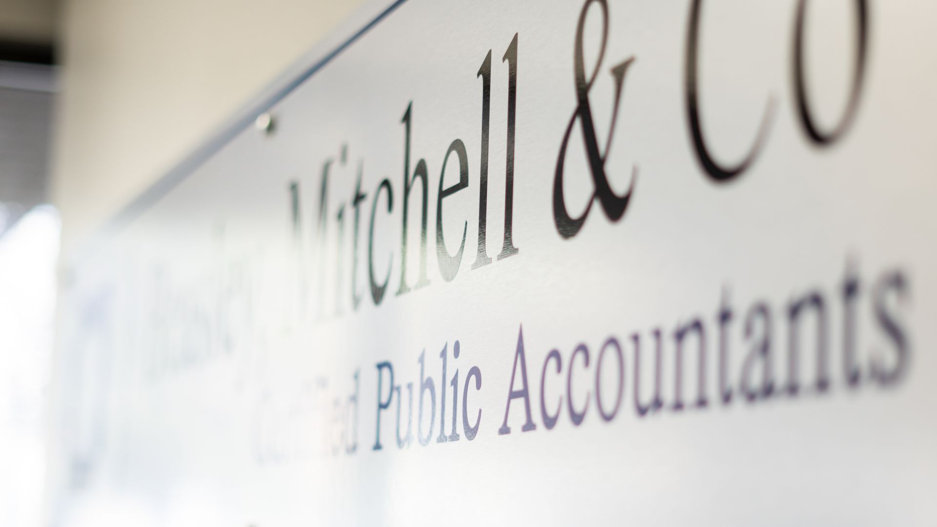 Sign for Mitchell & Co, Certified Public Accountants, white background, black text.