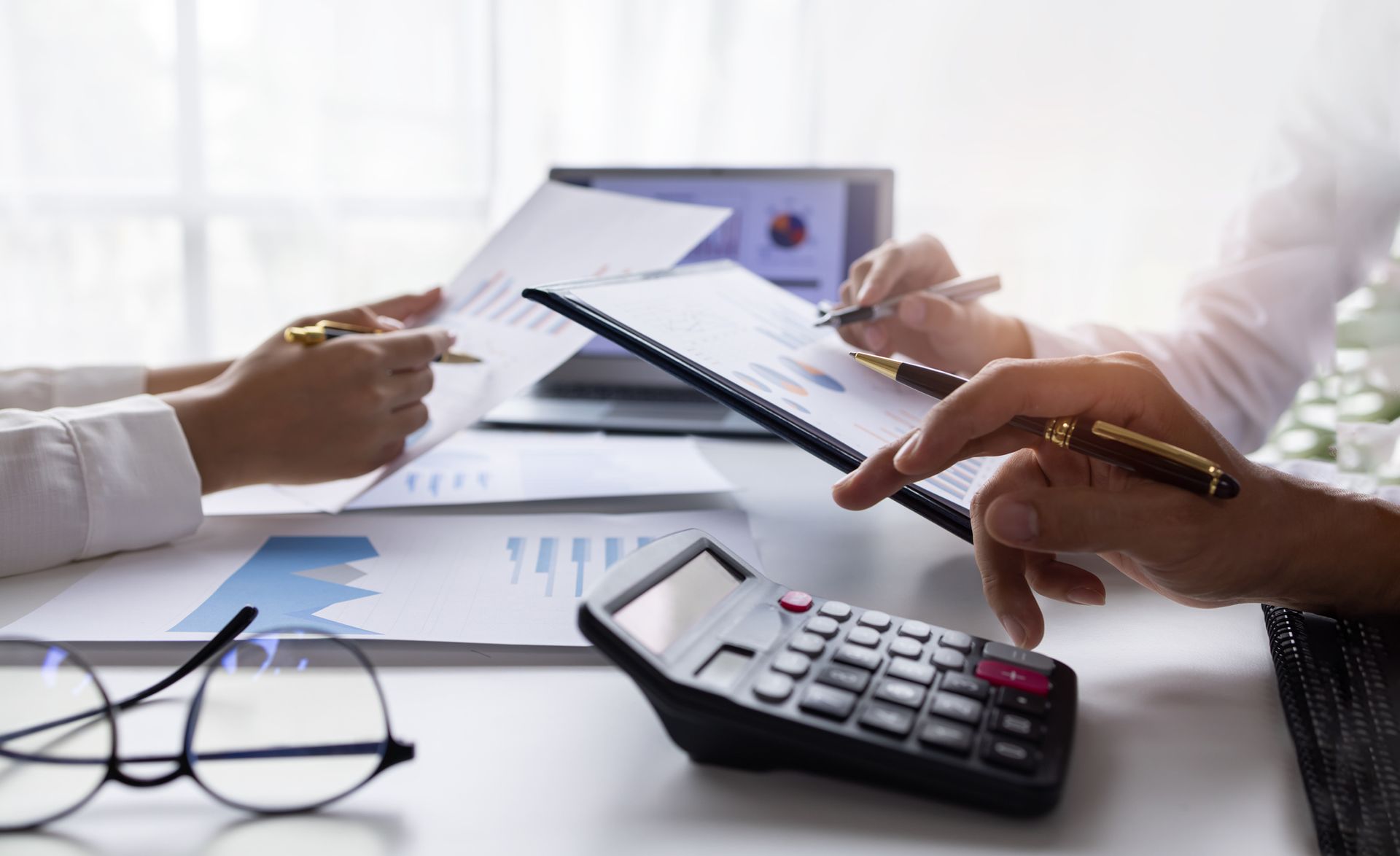 A team working at a workplace with documents, performing certified public accountant services.