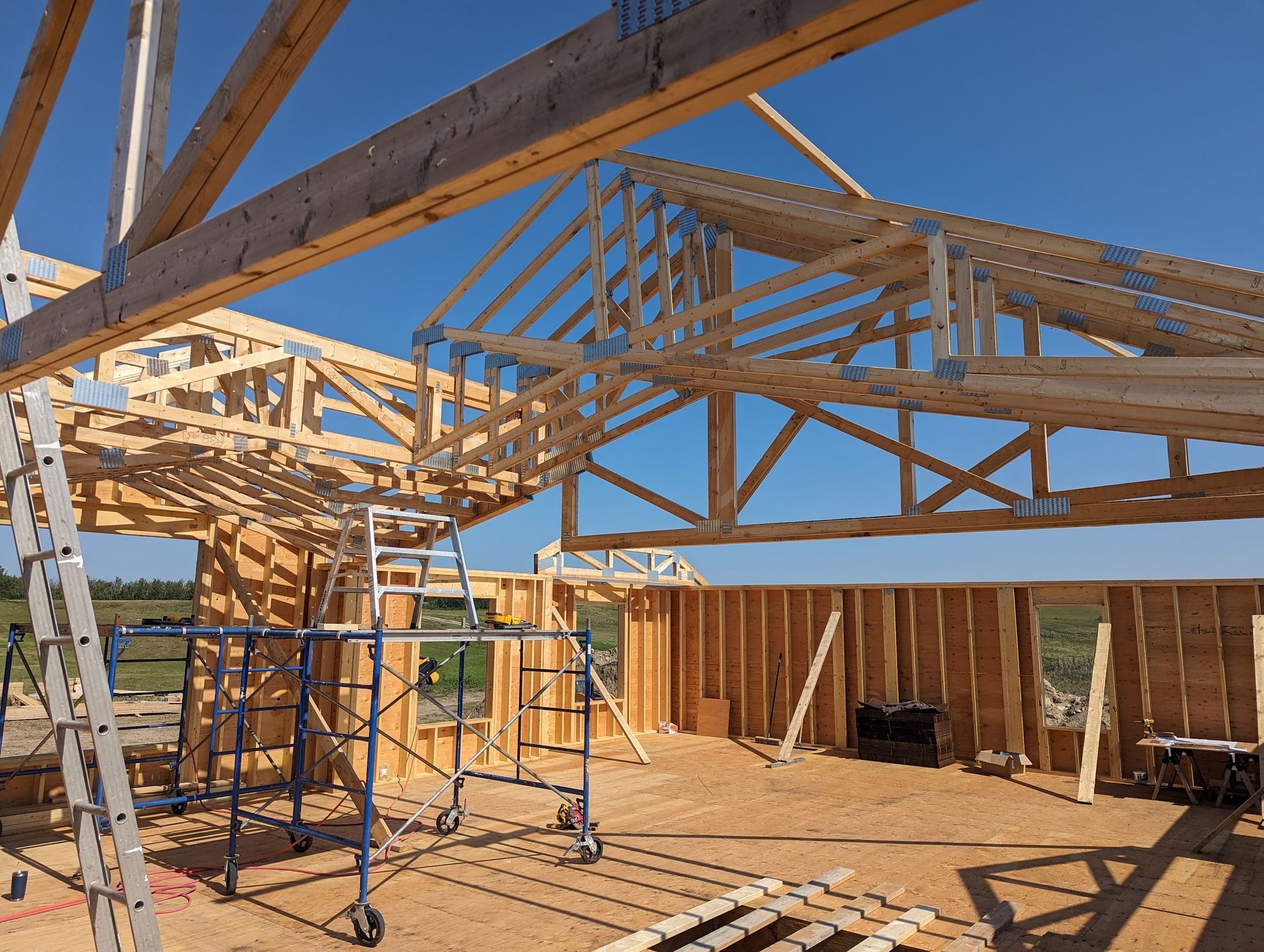 A house is being built with wooden beams and scaffolding.
