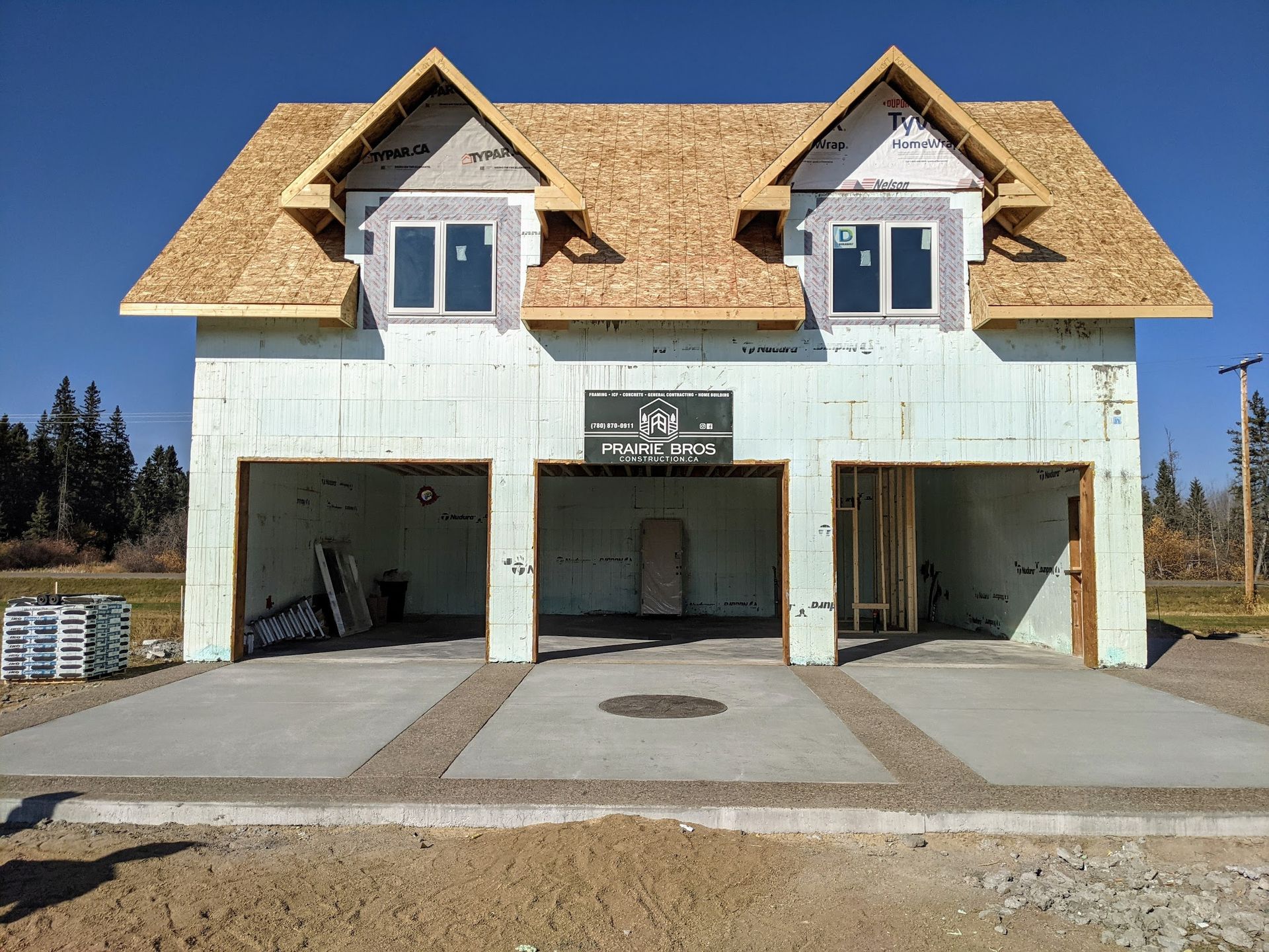 A house that is being built with a garage underneath it