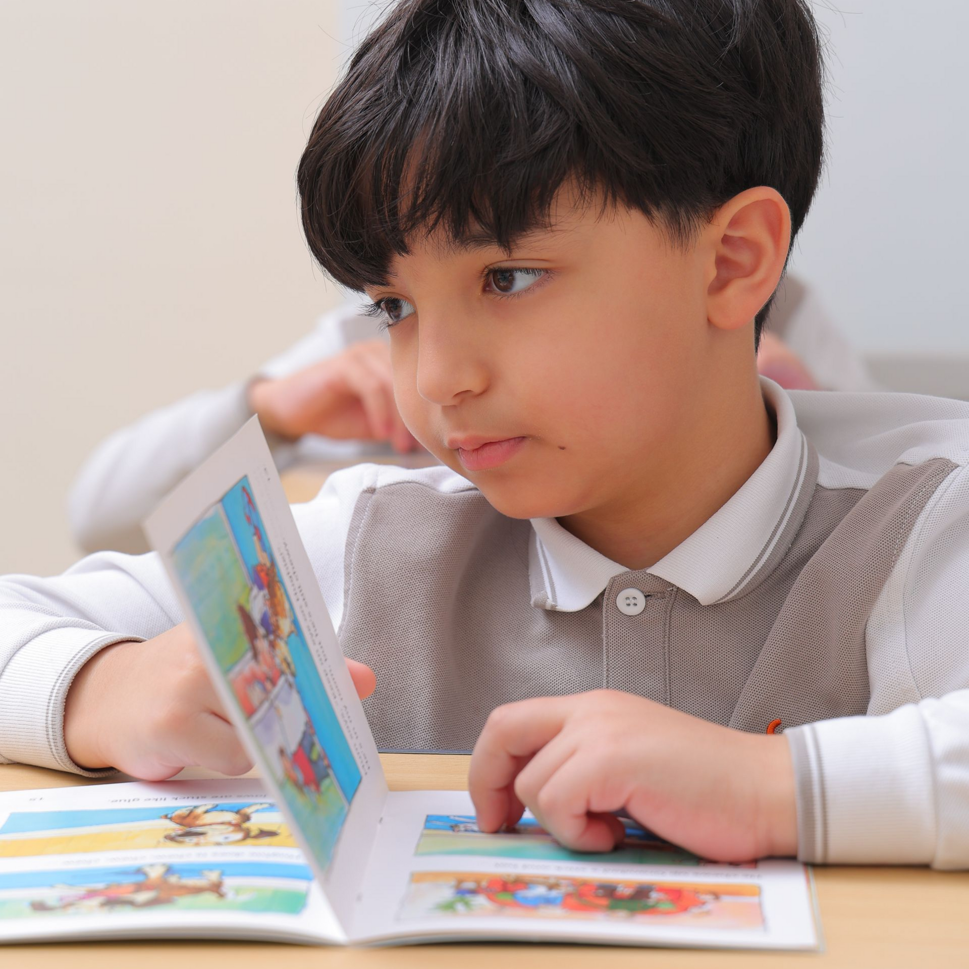 A boy and a girl are reading a book together