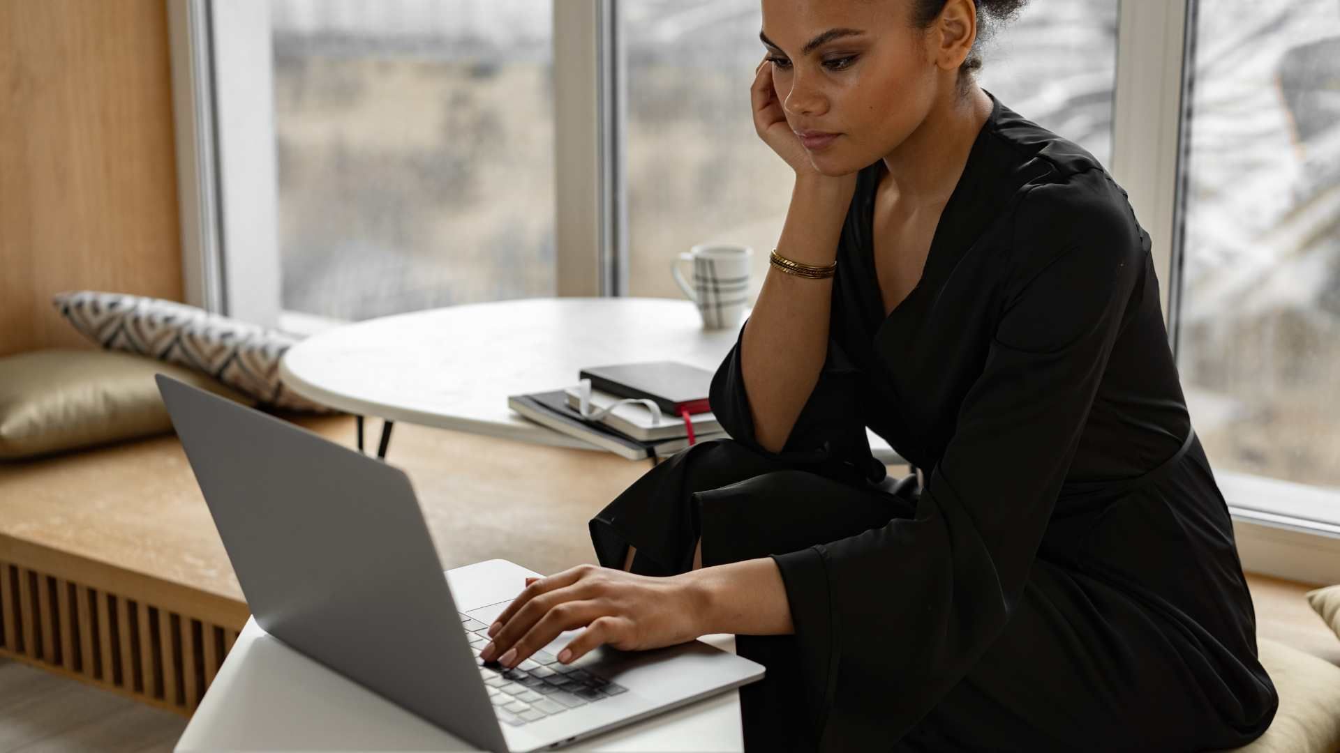 Black woman on laptop seeking mental health help