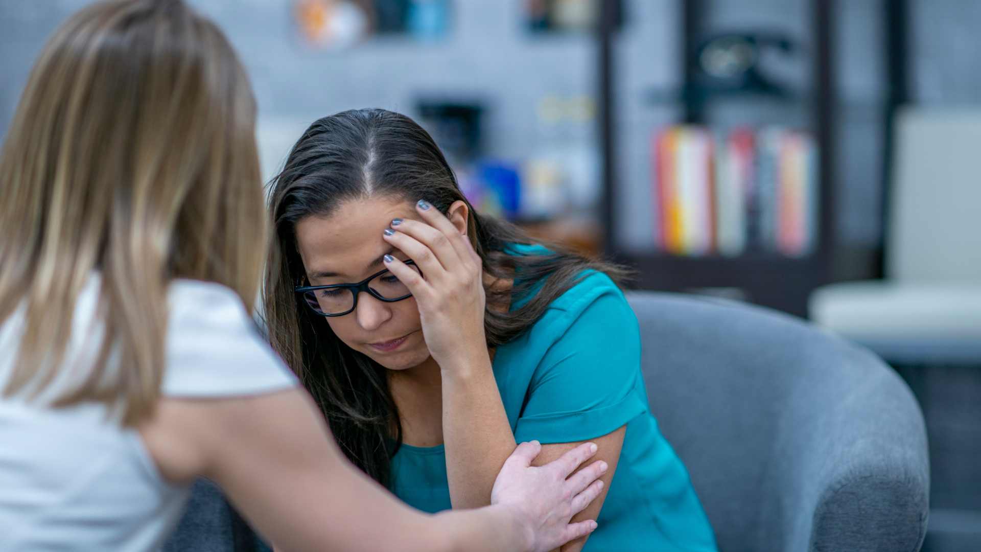 woman with his hand on her face being comforted by her therapist