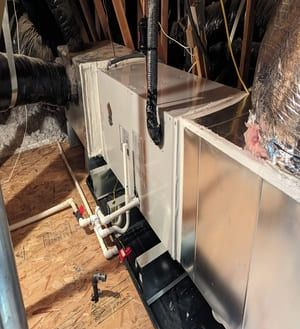 Air-source heat pump outdoor unit installed on east side of Woodland home