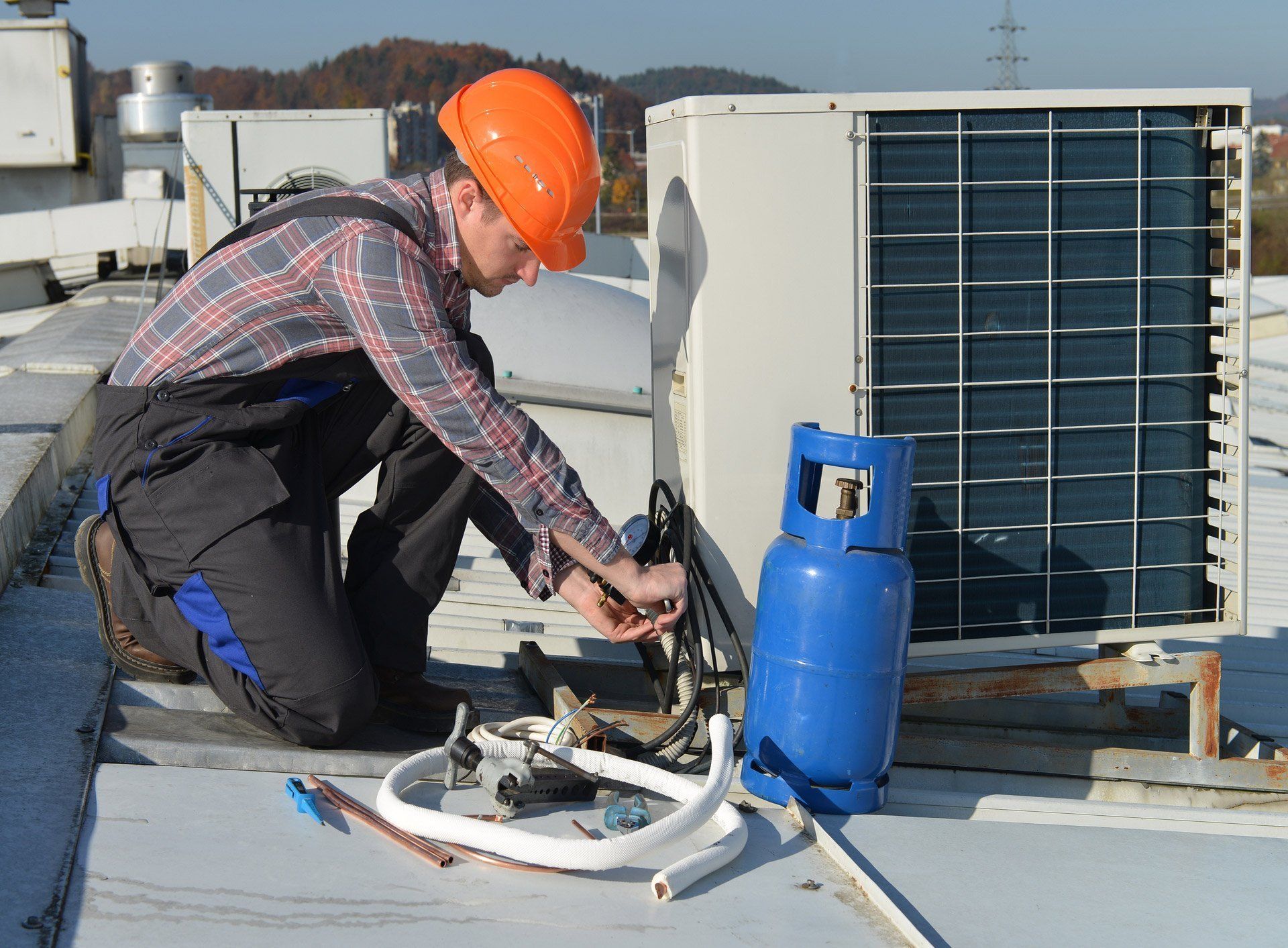 AC contractor addressing odor issue in outdoor unit
