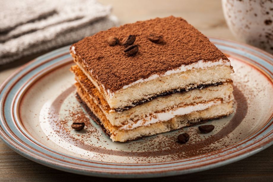 Classic Italian Tiramisu on dark slate plate