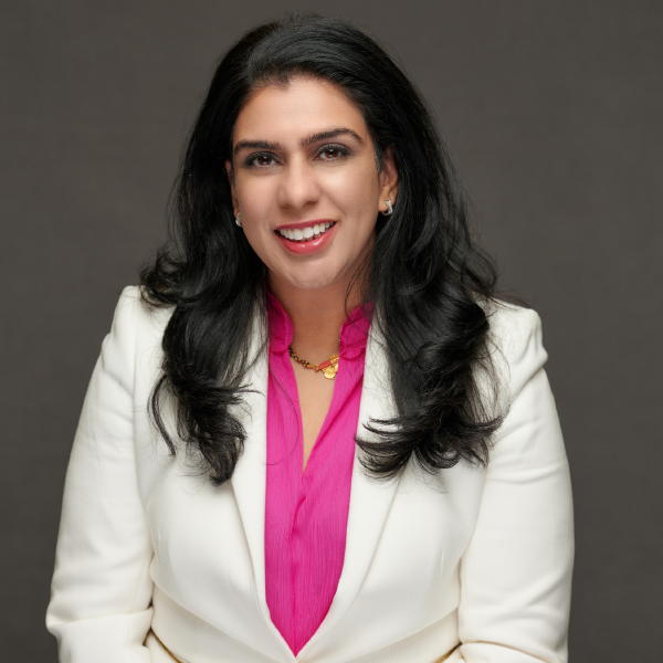 Anjuma Goswami Karkera, IBTS CEO, wearing a pink shirt and white blazer