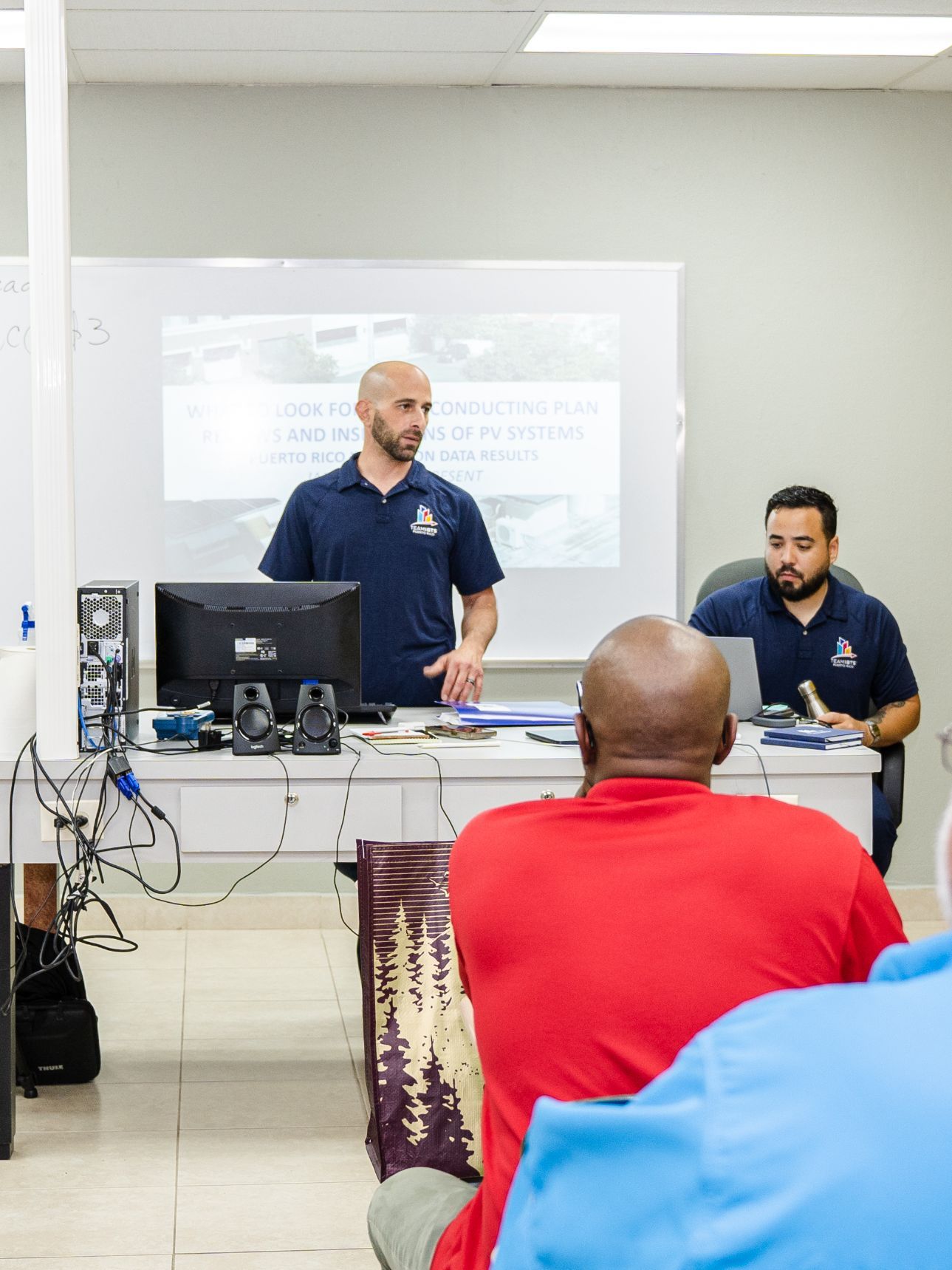 A man is giving a presentation in front of a group of people