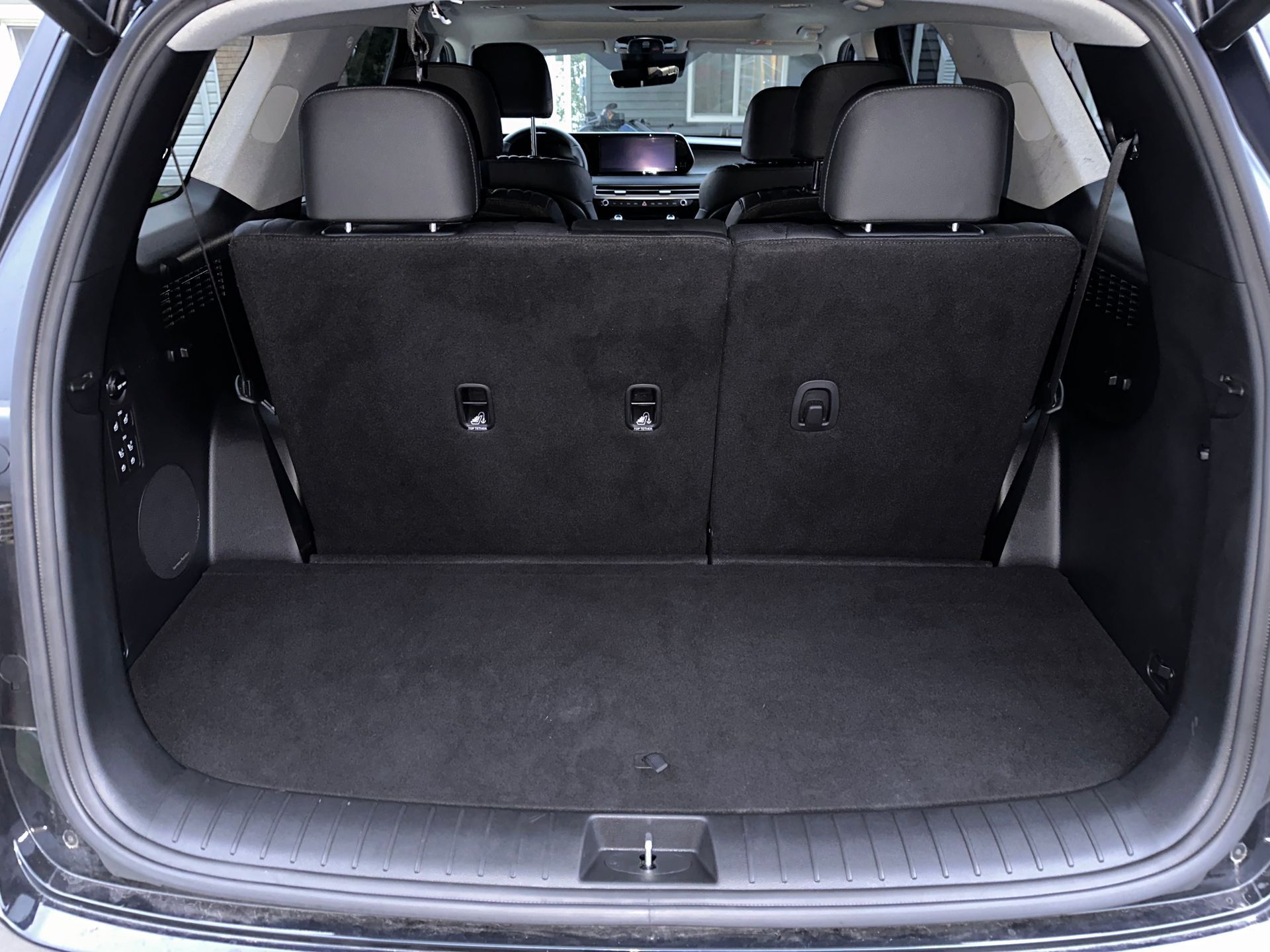 Empty black SUV cargo area with folded seats.