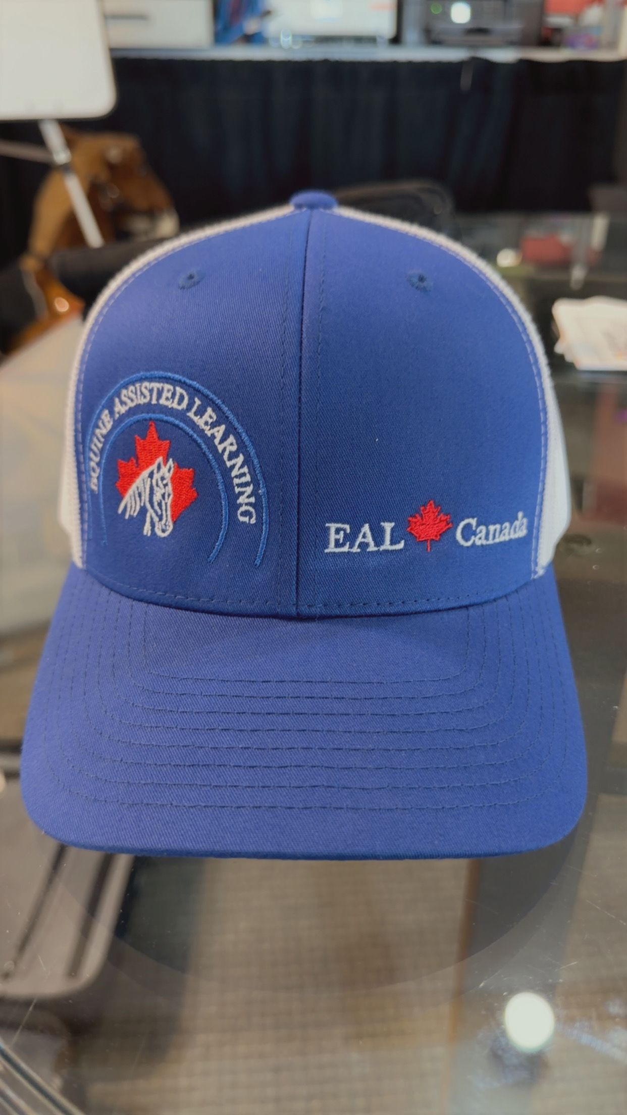 Red EAL baseball cap with embroidered logo and white text
