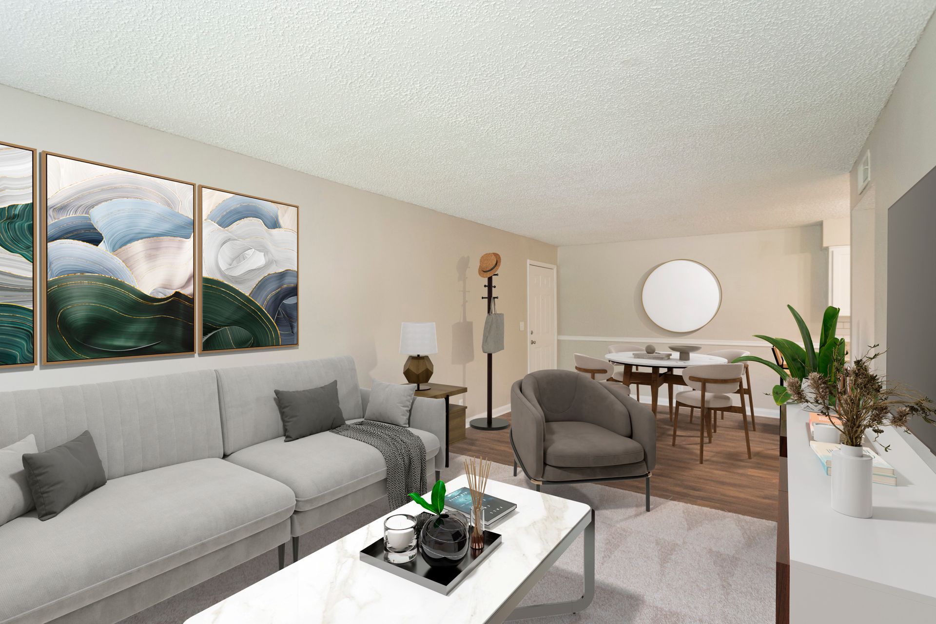 A modern, neutral-toned living room featuring a light gray sectional sofa, a coffee table, and an adjacent dining area.