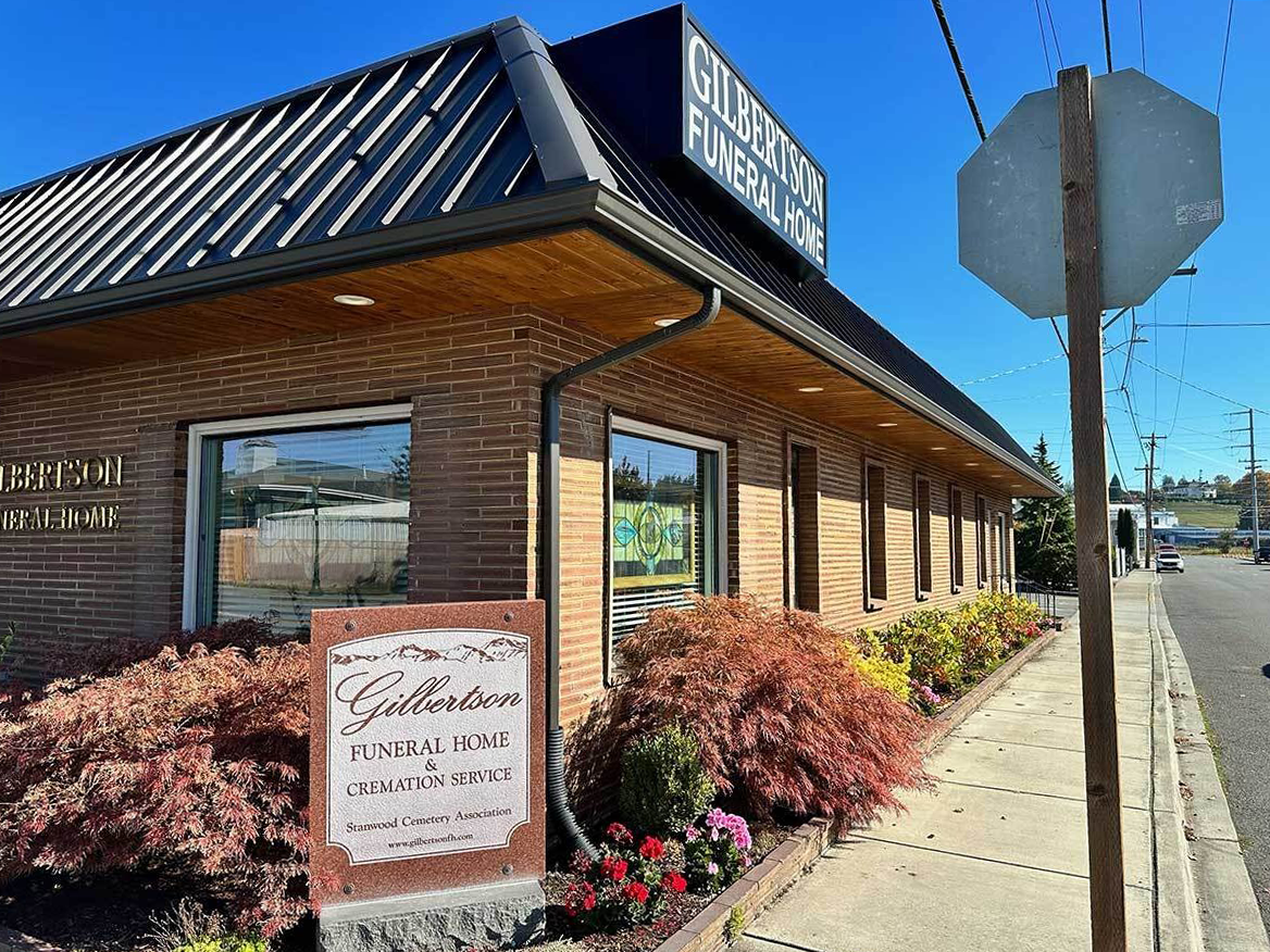 Hawthorne Funeral Home exterior, tan building, dark roof, sunny day.