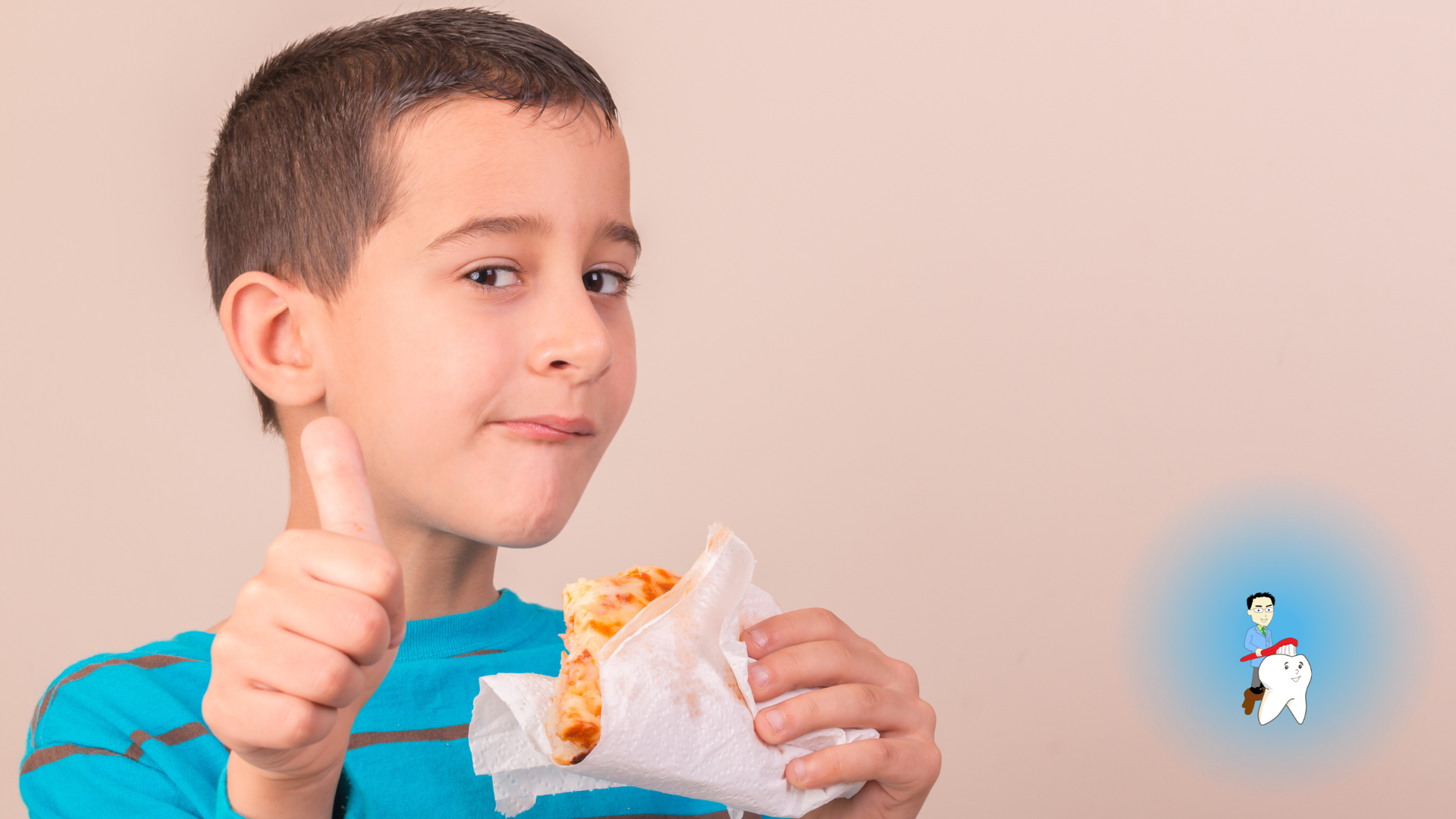 Smiling child in a blue shirt giving a thumbs-up while holding a sandwich wrapped in paper.