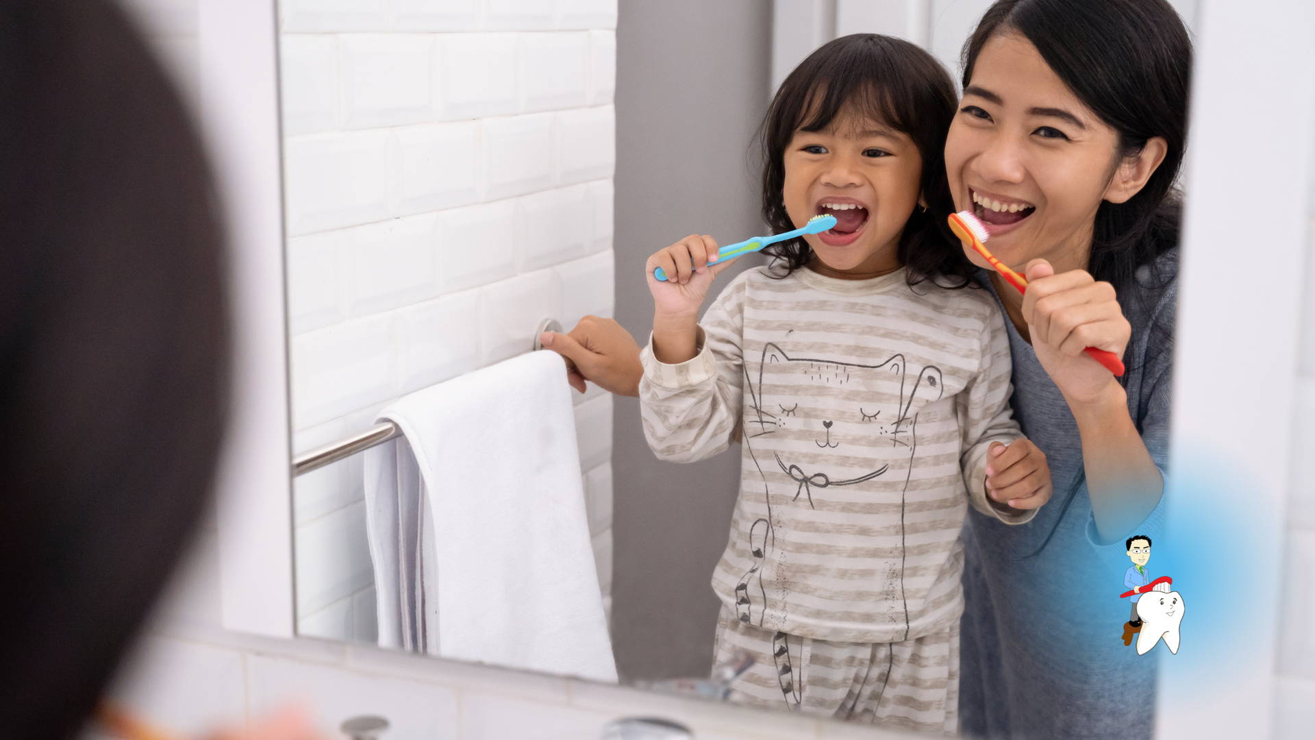 Woman and child brushing teeth together in a bathroom mirror, smiling.