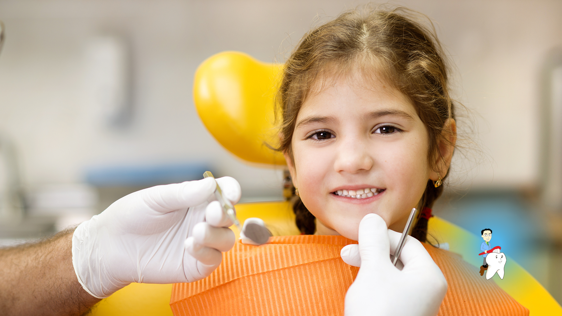 Child at the dentist, smiling while dental tools are used; yellow balloon in the background.
