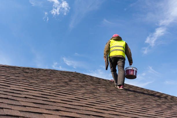 A Man Wearing A Hard Hat Is Working On A Roof — Huron, SD — Shaddai Construction