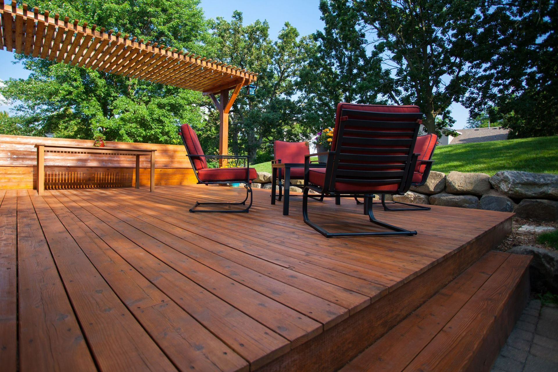 A Wooden Deck With A Pergola And Chairs — Huron, SD — Shaddai Construction A Wooden Deck With A Pergola And Chairs — Huron, SD — Shaddai Construction