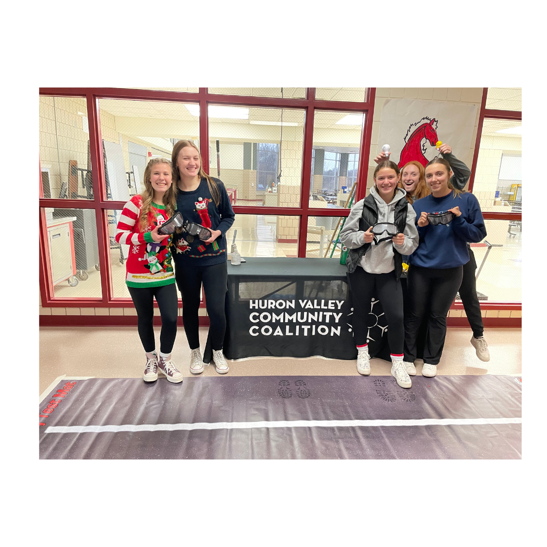 high school students demonstrating how to use the alcohol impairment simulation goggles