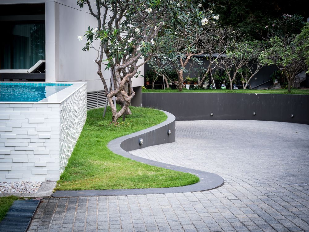 There is a Swimming Pool in the Backyard of a House — Brendan's Landscaping and Fencing In Bundaberg, QLD